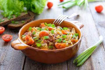 Stewed cabbage with onion and sausages