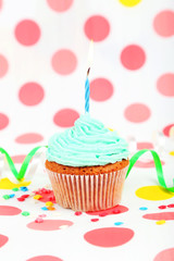 Birthday cupcake with butter cream and candle 
