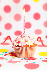Birthday cupcake with butter cream and candle 