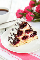 Cake on plate, on the white wooden background