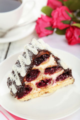 Cake on plate, on the white wooden background