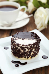 Cake on plate, on the brown wooden background