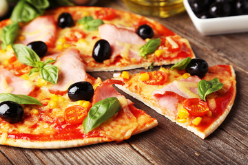 Delicious fresh pizza on brown wooden background