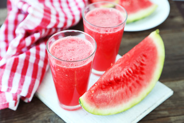 Watermelon smoothies on brown wooden background