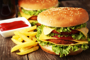 Big burgers on brown wooden background