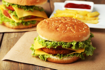 Big burger on brown wooden background