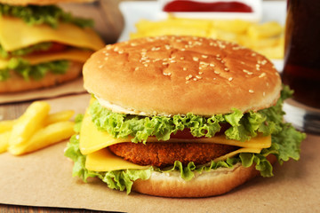 Big burger on brown wooden background