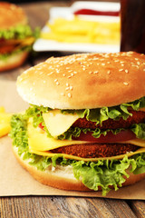 Big burger on brown wooden background