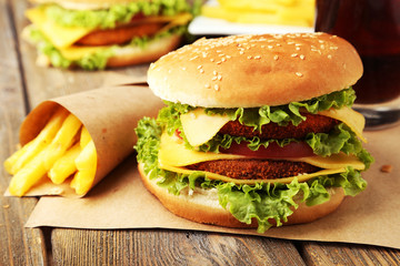 Big burgers on brown wooden background