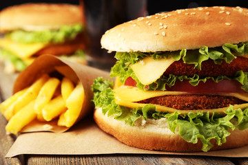 Big burger on brown wooden background