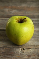 Green apple on grey wooden background