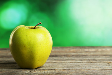 Green apple on grey wooden background
