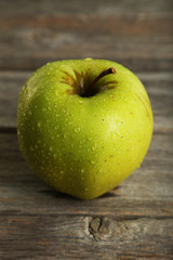 Green apple on grey wooden background