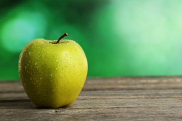 Green apple on grey wooden background