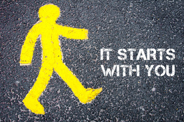 Pedestrian figure walking towards IT STARTS WITH YOU