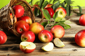 Apples in basket on brown wooden background