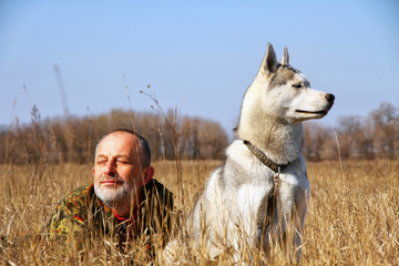 Old man playing with the dog