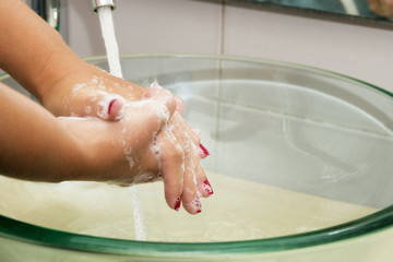 Hands washing with soap under running water