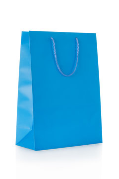 Blue shopping bag in paper isolated on white, clipping path incl