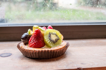 fresh fruit pie tart with kiwi, blueberry, orange and strawberry