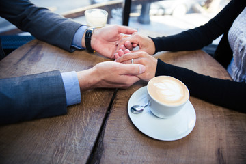 Man holding his girlfriend's hand at the restaurant