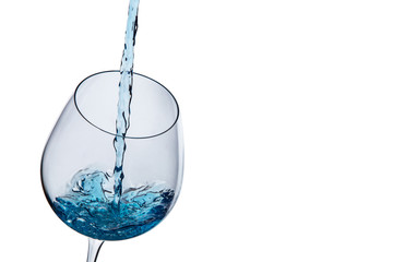 Water poured into a glass on a white background