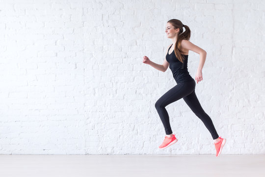 Side View Of Active Sporty Young Running Woman Runner Athlete