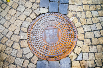 Hatch of sewage on the paving road