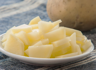 sliced raw potato on kitchen table