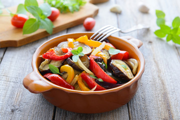 Hot salad from roasted aubergines and sweet pepper