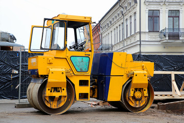 Heavy yellow roller compactor asphalting