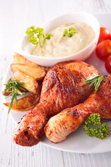 grilled chicken leg, sauce and french fries