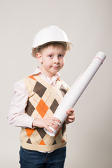 Boy in a construction helmet holding a drawing