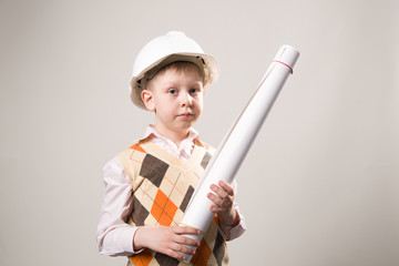 Boy in a construction helmet holding a drawing