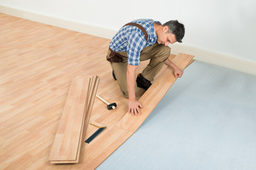 Man Installing New Laminated Wooden Floor