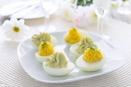 Eggs stuffed with cheese and avocado mousse