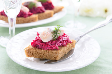 Obraz na płótnie Canvas Canape with beetroot pesto and herring