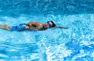 Boy swimming in pool