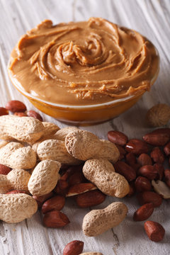 Tasty peanut butter in a bowl close up vertical

