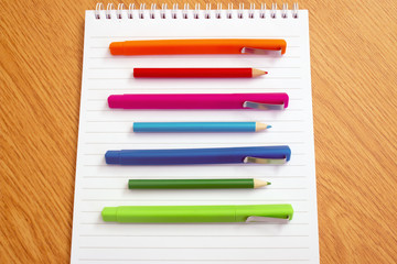 Fototapeta premium colored pens on a notepad on the table