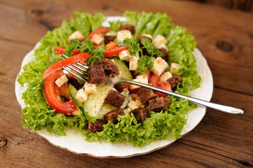 Vegetable salad made of lettuce, cucumbers, tomatoes, cheese and