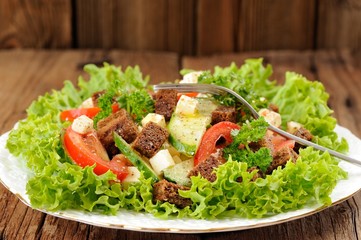 Vegetable salad made of lettuce, cucumbers, tomatoes, cheese and