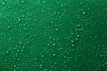 Water drops on green background