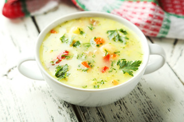 Bowl of soup on white wooden background