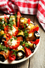 Tasty eggplant rolls on wooden background