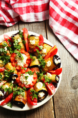 Tasty eggplant rolls on wooden background