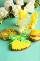 Fototapeta na wymiar Heart shaped cookies with candies on green background