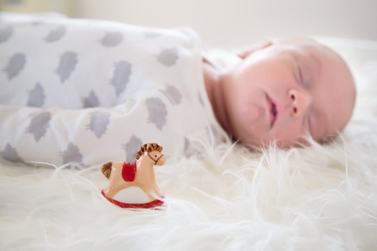 sleeping baby with toy horse