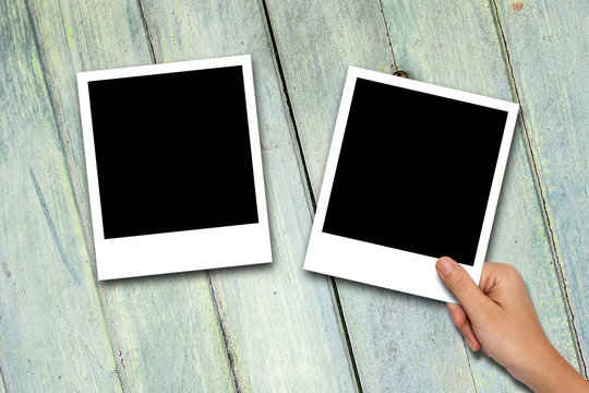 Blank photo frames on wood background