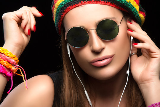 Fashionable Young Woman Enjoying Music Through Headphone